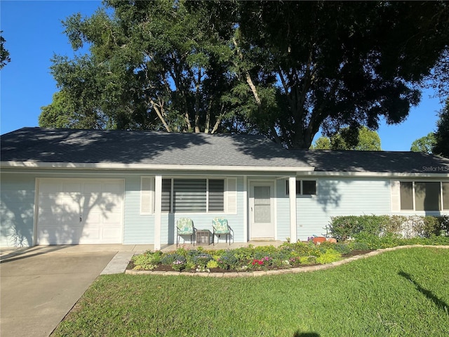 single story home with a garage and a front lawn