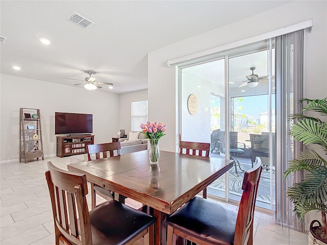 tiled dining area featuring ceiling fan