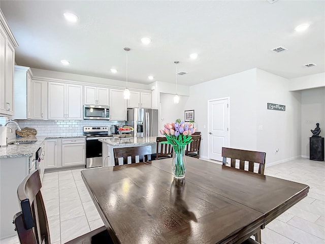 tiled dining area featuring sink