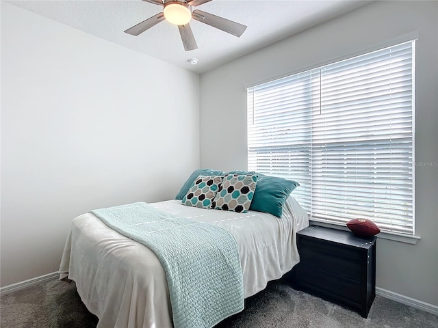 bedroom featuring dark carpet and ceiling fan