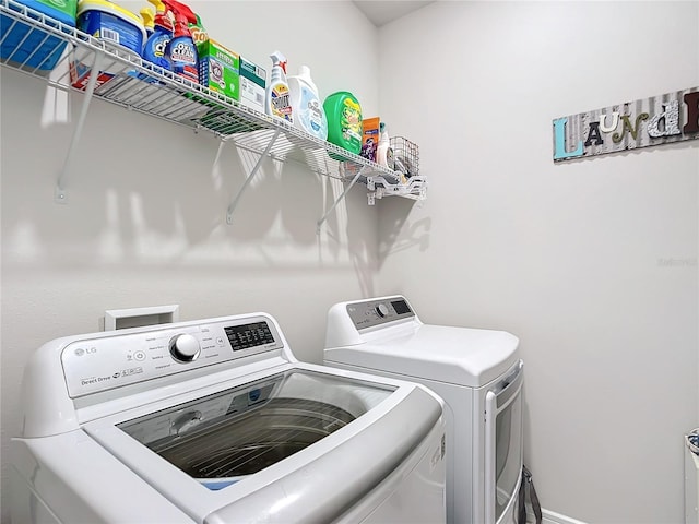 washroom featuring washing machine and dryer