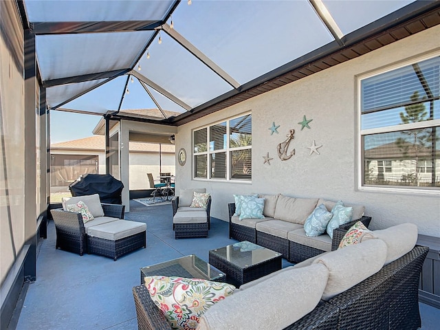 view of patio / terrace with an outdoor living space and glass enclosure