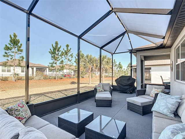 view of patio featuring grilling area and glass enclosure