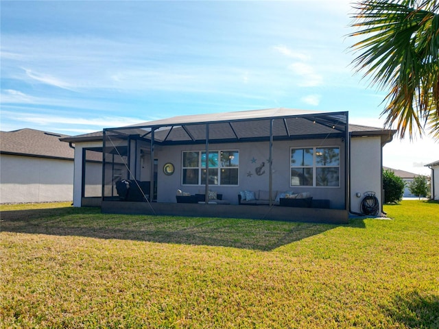 back of property with glass enclosure and a lawn