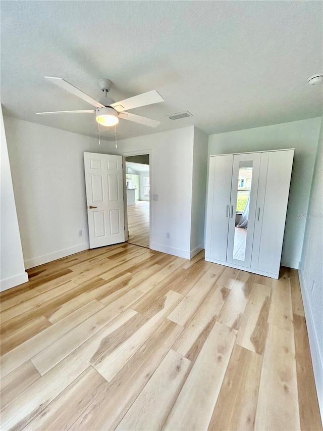 spare room with ceiling fan and light hardwood / wood-style floors