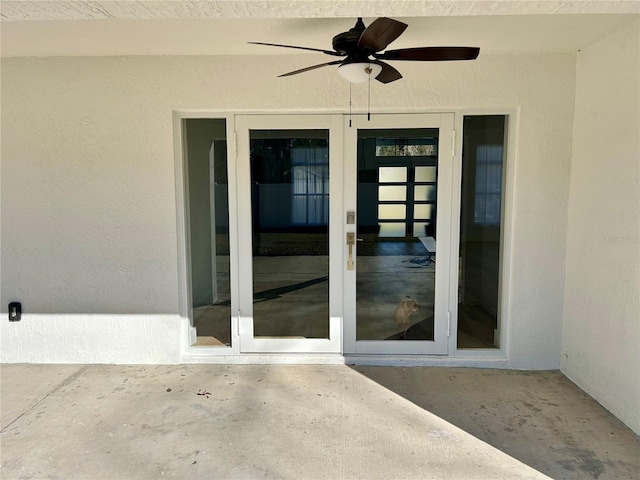 property entrance with a patio and ceiling fan