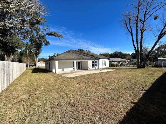 rear view of house featuring a yard and a patio area