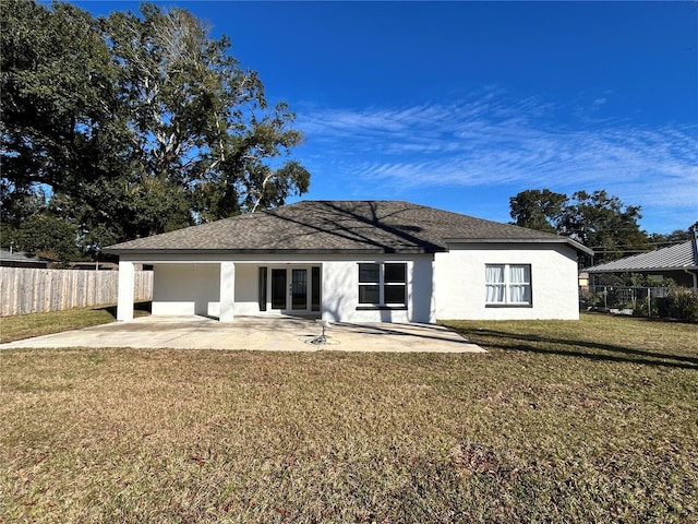 back of house with a yard and a patio area