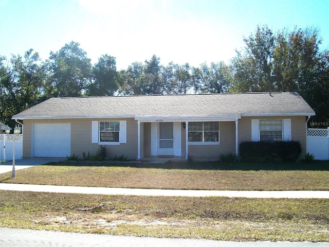 ranch-style house featuring a front yard and a garage