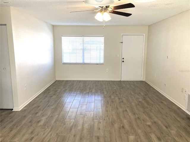 unfurnished room with a textured ceiling, dark hardwood / wood-style flooring, and ceiling fan