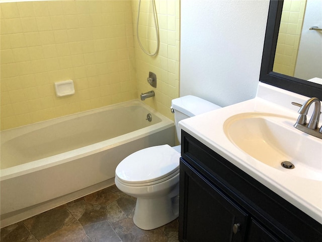 full bathroom with tiled shower / bath combo, toilet, and vanity