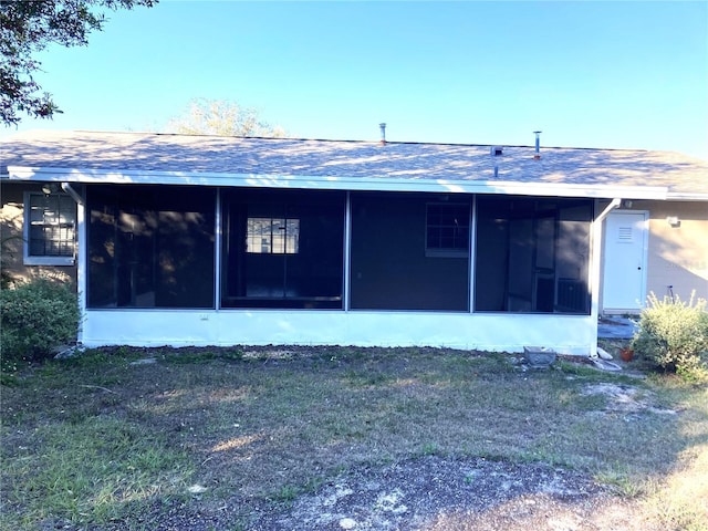 rear view of property with a sunroom