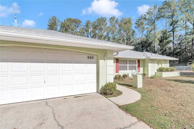 ranch-style home with a garage and a front yard