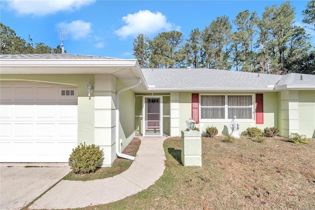 single story home featuring a front yard and a garage