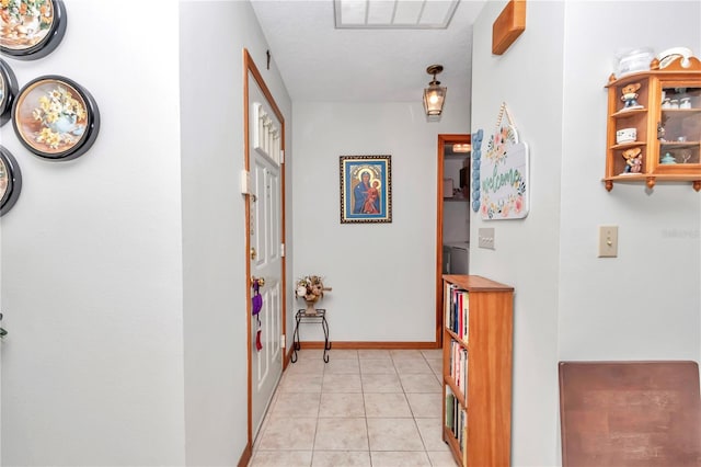 hall with light tile patterned floors and a textured ceiling