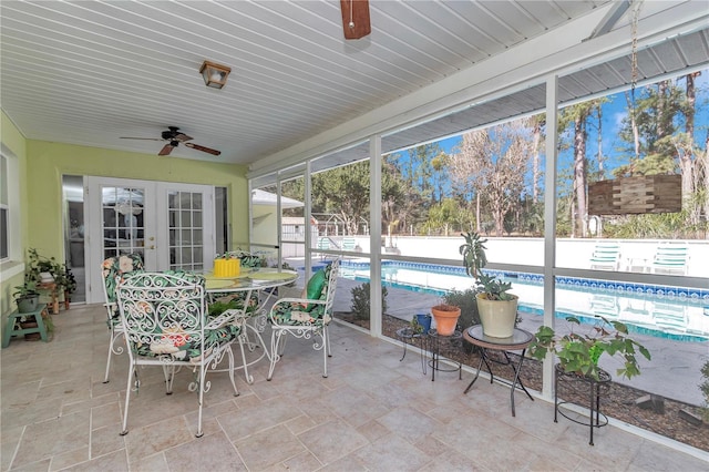 sunroom / solarium with ceiling fan and french doors