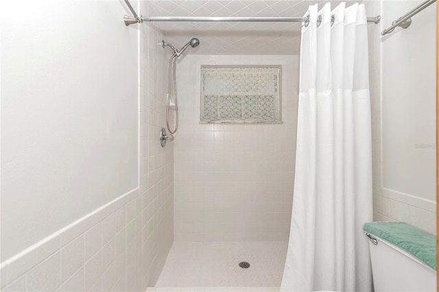 bathroom with walk in shower, toilet, and tile walls