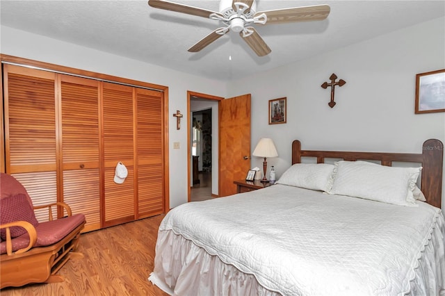 bedroom with a closet, ceiling fan, and light hardwood / wood-style floors