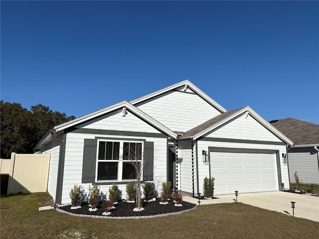 view of front of property featuring an attached garage, driveway, and fence