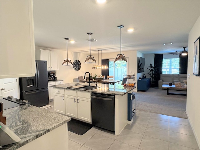 kitchen with dishwasher, refrigerator with ice dispenser, pendant lighting, a center island with sink, and white cabinetry