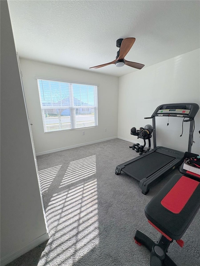 workout area with ceiling fan and carpet