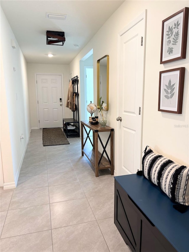 hall featuring light tile patterned flooring