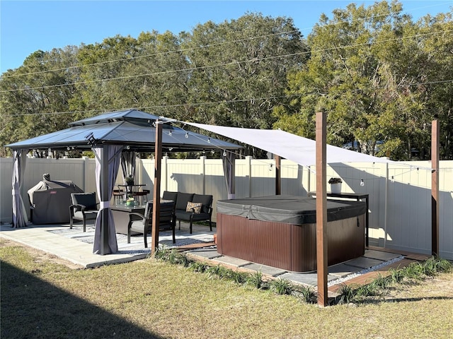 exterior space with a patio area, a gazebo, a hot tub, a yard, and an outdoor living space