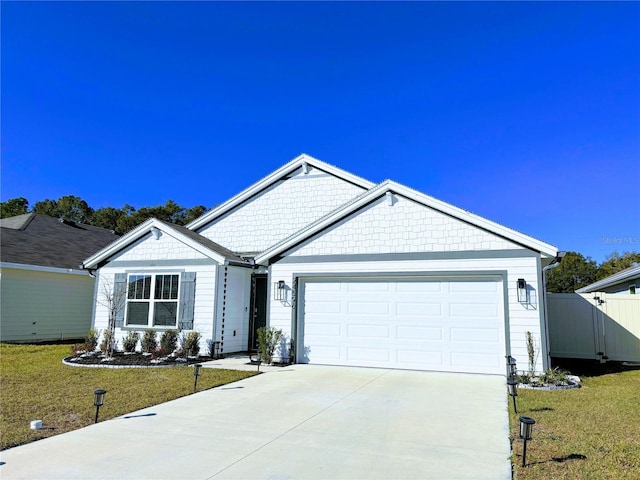 single story home with a garage, a front yard, driveway, and fence