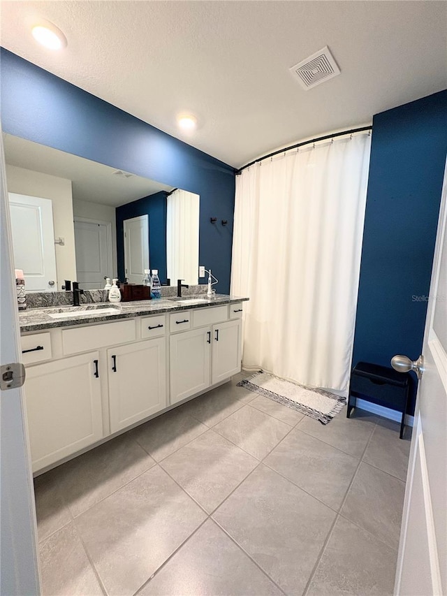 bathroom with tile patterned floors and vanity