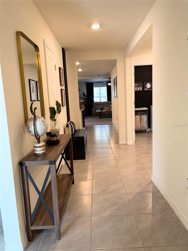 hall featuring light tile patterned floors