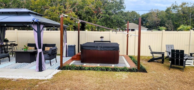 view of yard featuring an outdoor fire pit, a hot tub, and a gazebo