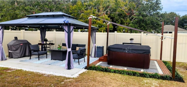 view of patio with a gazebo, a hot tub, and a grill