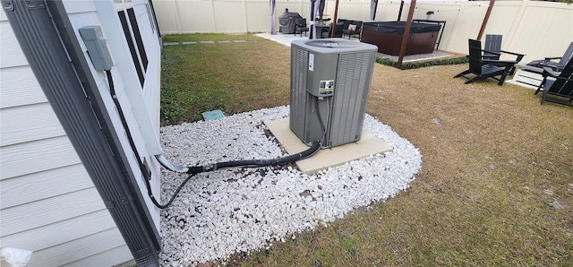 exterior details featuring central air condition unit and a hot tub