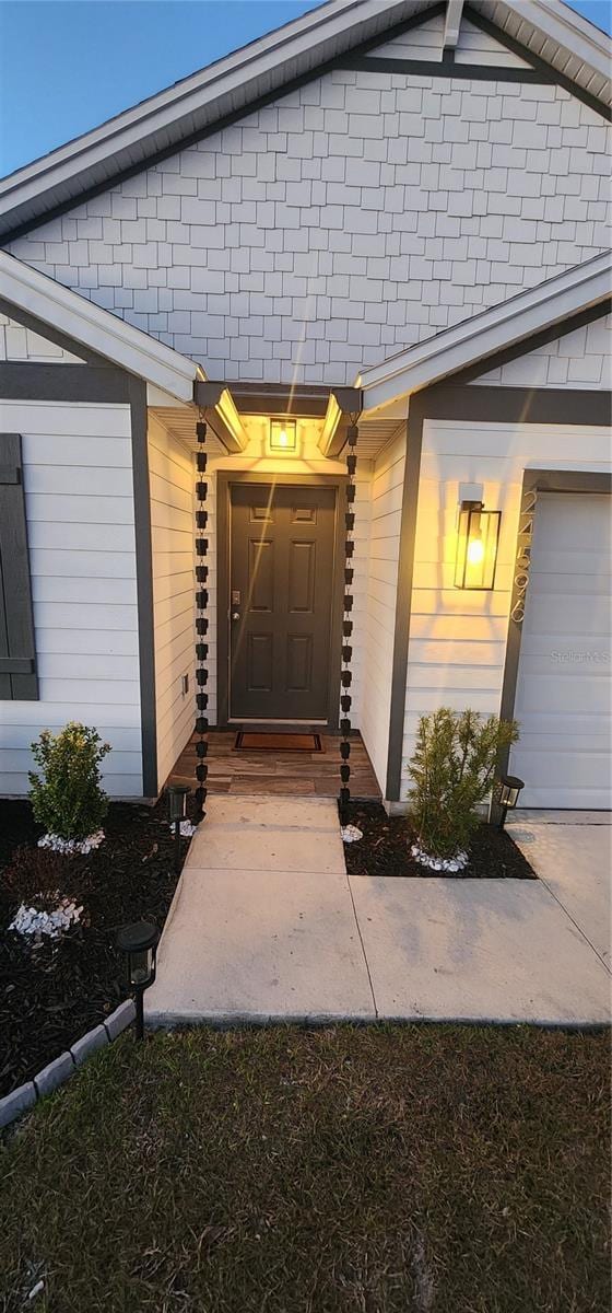 view of exterior entry with a garage