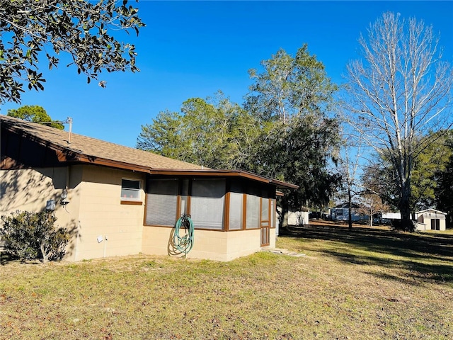 view of home's exterior with a lawn