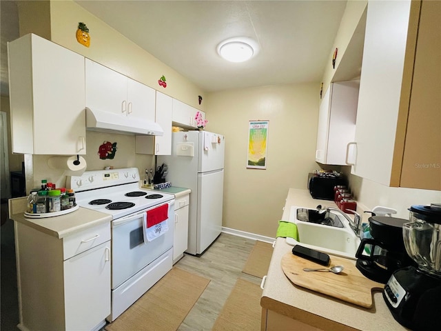 kitchen featuring white appliances, light hardwood / wood-style floors, and white cabinetry