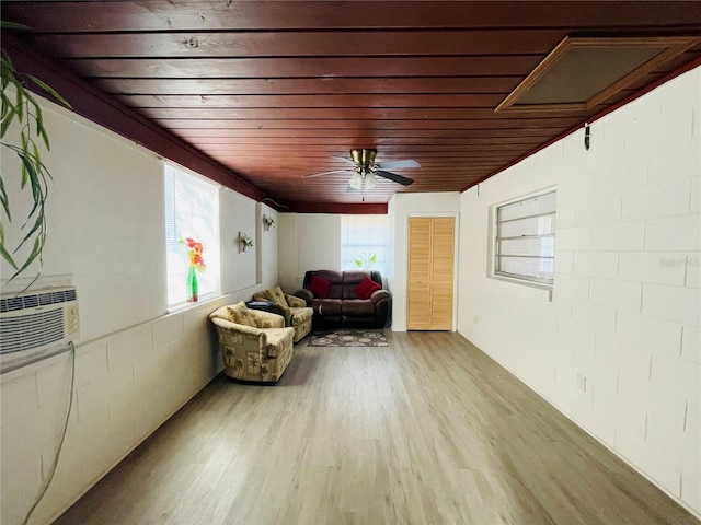 living area with hardwood / wood-style flooring, ceiling fan, and wooden ceiling