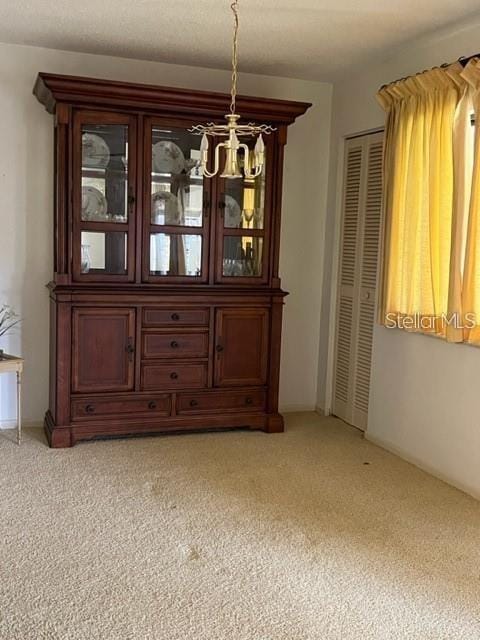 unfurnished dining area featuring light colored carpet