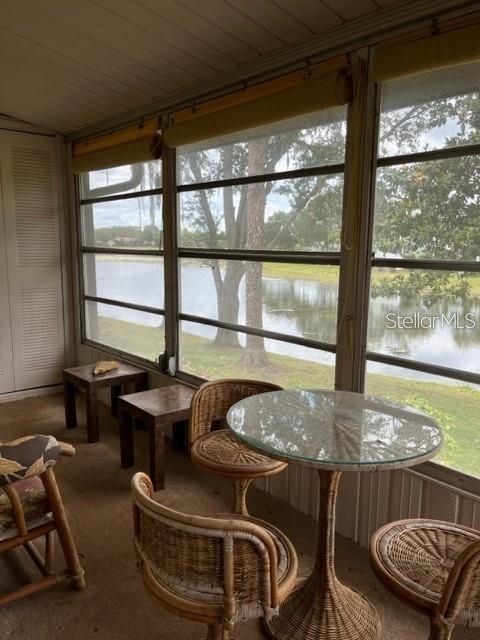 sunroom / solarium with a wealth of natural light and a water view