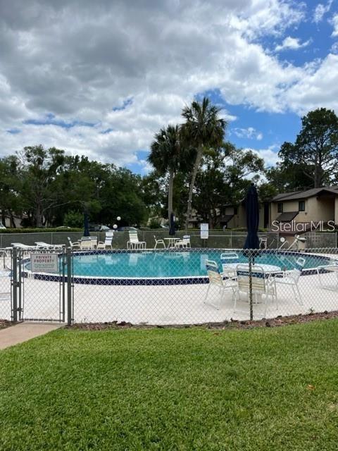 view of pool featuring a yard and a patio area