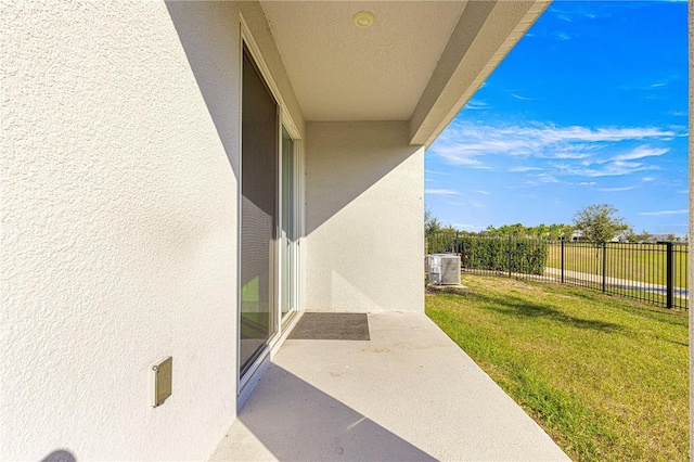 exterior space featuring a yard, a patio, and central AC