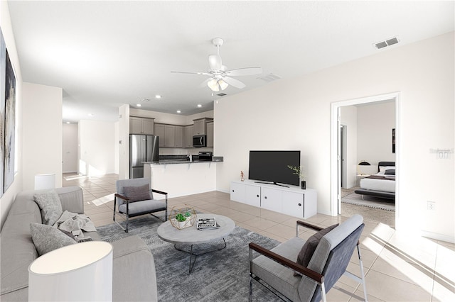 tiled living room featuring ceiling fan