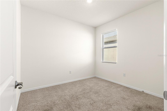 unfurnished room with light carpet and a textured ceiling