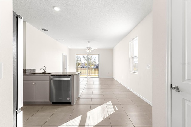 kitchen featuring appliances with stainless steel finishes, ceiling fan, sink, light tile patterned floors, and gray cabinets