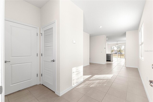 corridor with light tile patterned flooring