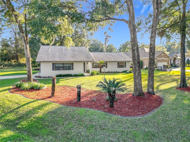 ranch-style home featuring a front yard