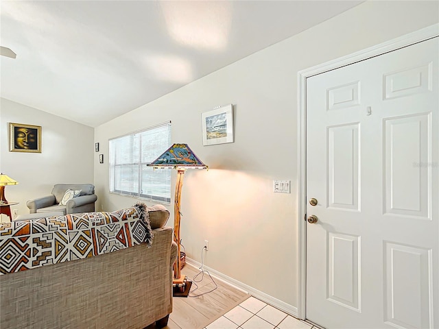 living room with lofted ceiling and light tile patterned floors