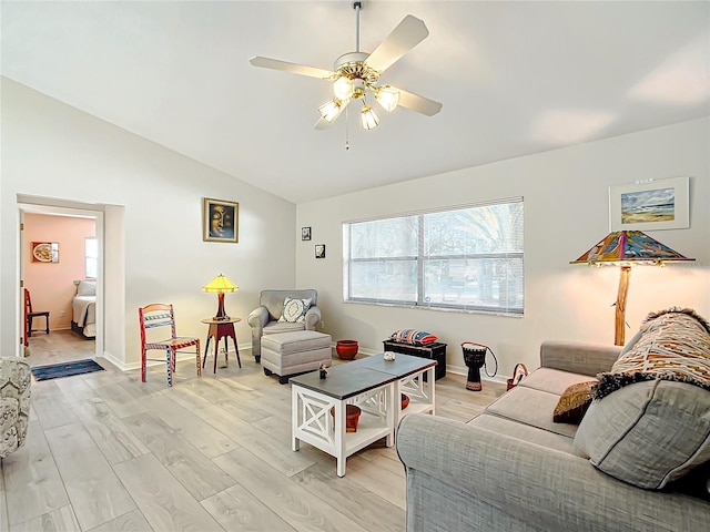 living room featuring light wood-type flooring, vaulted ceiling, and ceiling fan