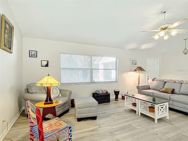 living room featuring ceiling fan and light hardwood / wood-style floors