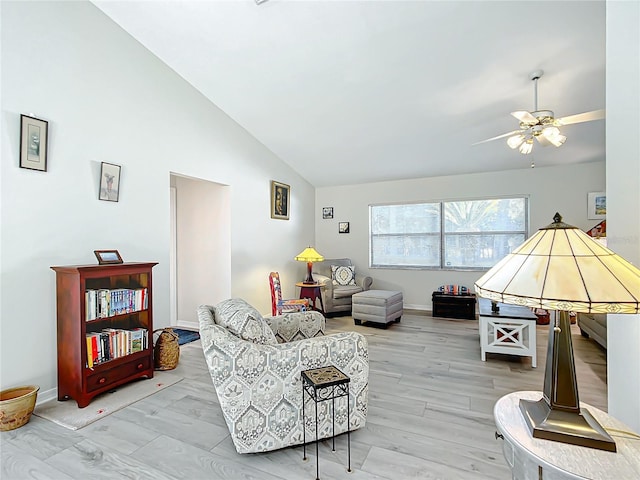 living room featuring ceiling fan, light hardwood / wood-style flooring, and lofted ceiling